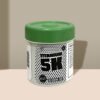 A plastic jar labeled "Titanium 5K" with green lid and text detailing male enhancement benefits